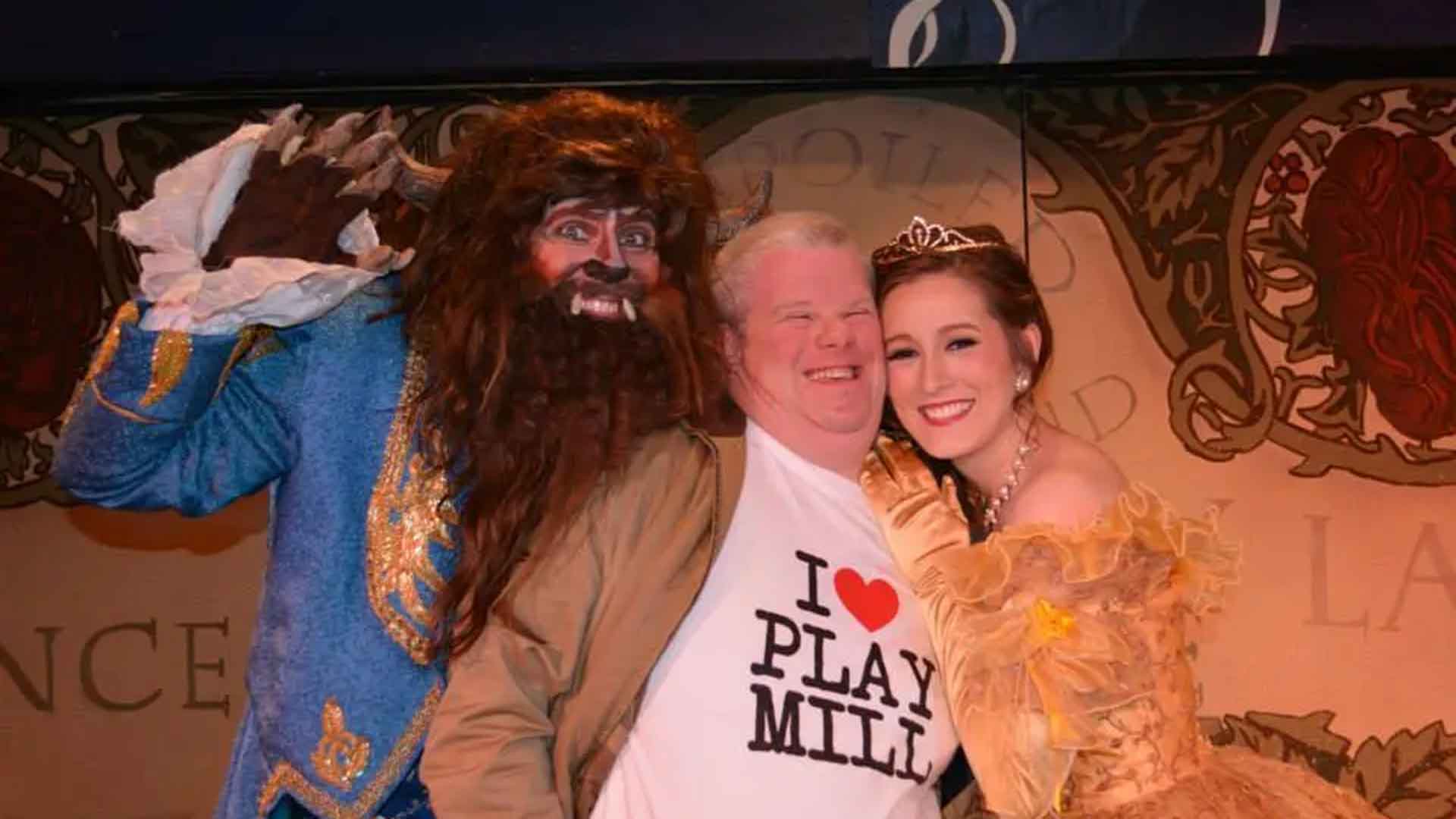 Fan wearing I Love Playmill shirt posing with Beauty and the Beast cast members at the Playmill Theatre Island Park Idaho
