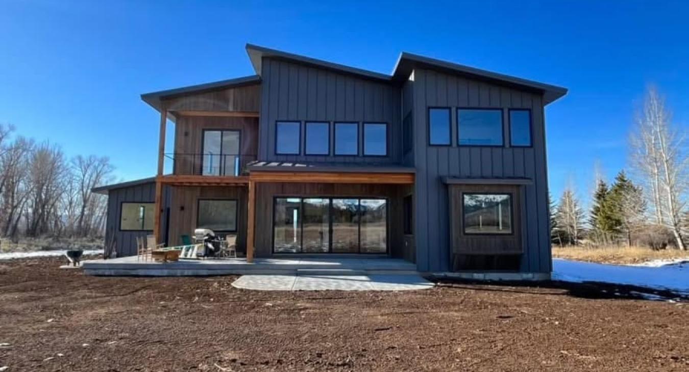 Finn Construction custom modern farmhouse exterior with board and batten siding and large windows in Eastern Idaho