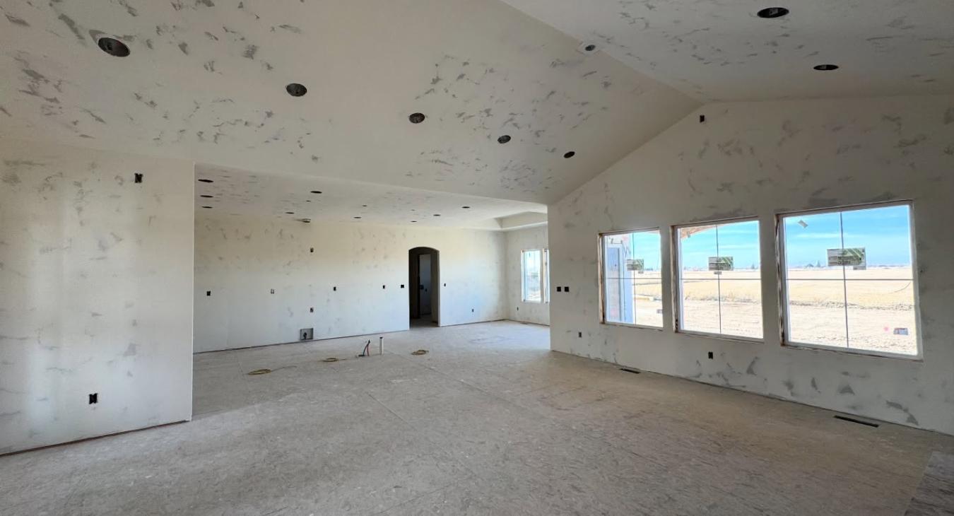 Open concept great room interior under construction with vaulted ceiling and recessed lighting by Finn Construction Custom Homes Eastern Idaho