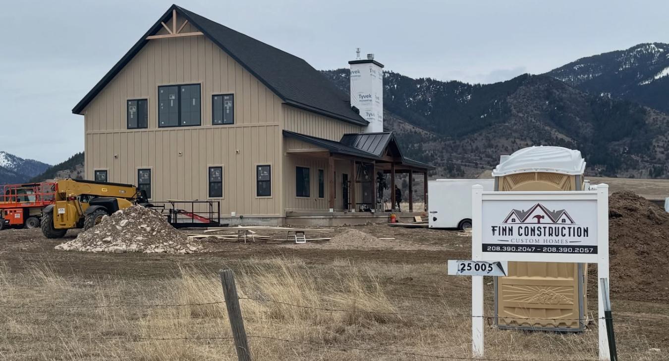 Finn Construction Custom Homes job site with modern farmhouse under construction and mountain views in Eastern Idaho