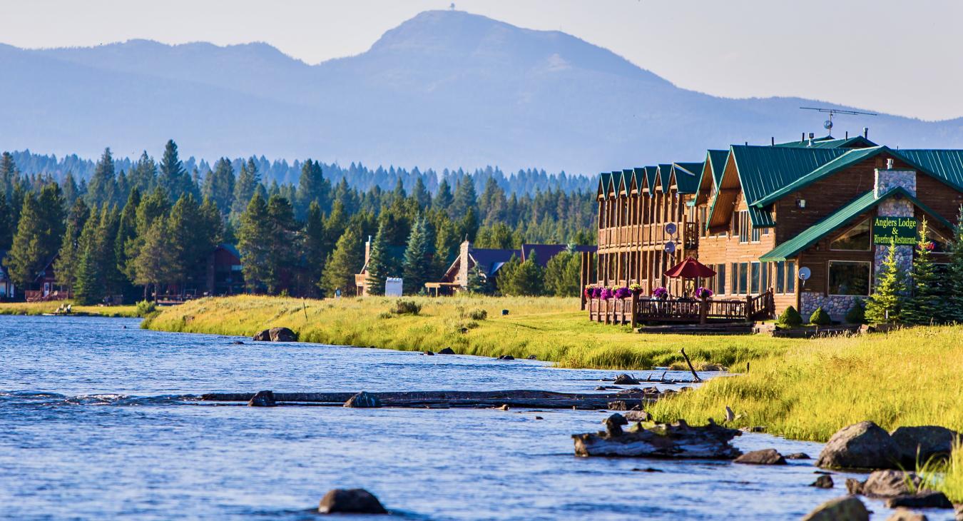 Anglers Lodge and Riverfront Restaurant on the banks of the Henry's Fork of the Snake River in Island Park Idaho with mountain views