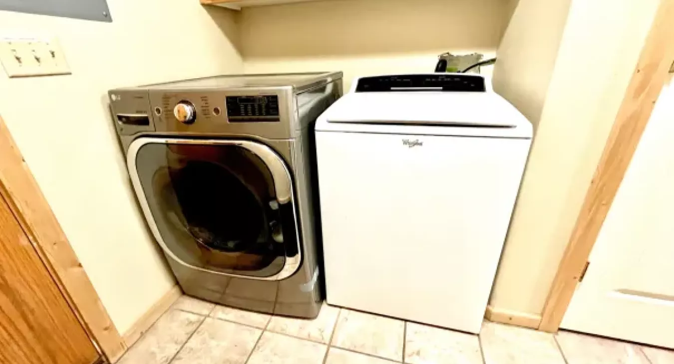 In-cabin laundry room with full size washer and dryer at Yellowstone Log Cabin Island Park Idaho