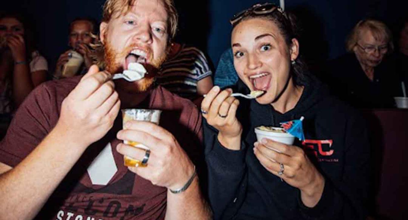 Couple enjoying ice cream sundaes in their seats during intermission at the Playmill Theatre Island Park Idaho