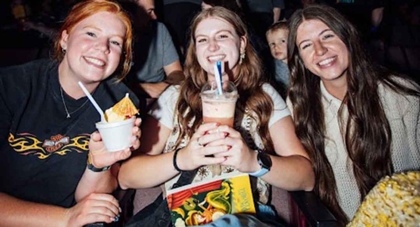 Guests enjoying Dole Whip and drinks in their seats during intermission at the Playmill Theatre Island Park Idaho