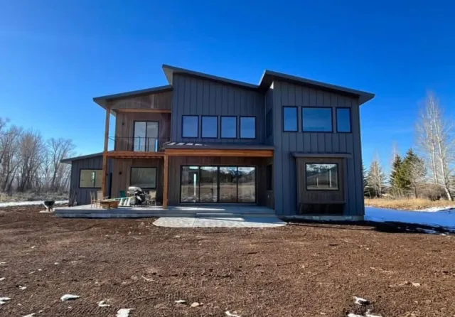 Finn Construction custom modern farmhouse exterior with board and batten siding and large windows in Eastern Idaho