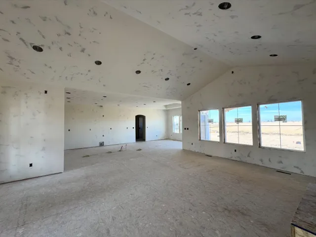 Open concept great room interior under construction with vaulted ceiling and recessed lighting by Finn Construction Custom Homes Eastern Idaho