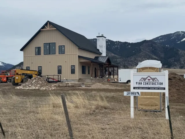 Finn Construction Custom Homes job site with modern farmhouse under construction and mountain views in Eastern Idaho